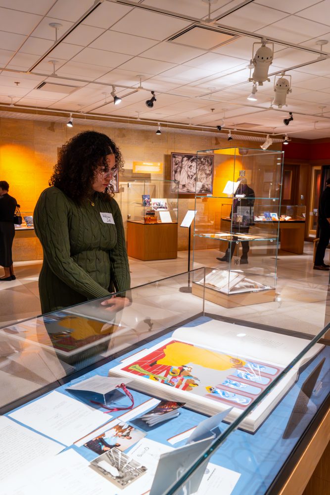 Attendees walk through "The Circle Unbroken," an exhibit celebrating the 40th anniversary of the Givens Collection. (Photo/Craig Bares)
