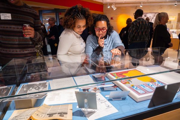 Attendees walk through "The Circle Unbroken," an exhibit celebrating the 40th anniversary of the Givens Collection. (Photo/Craig Bares)