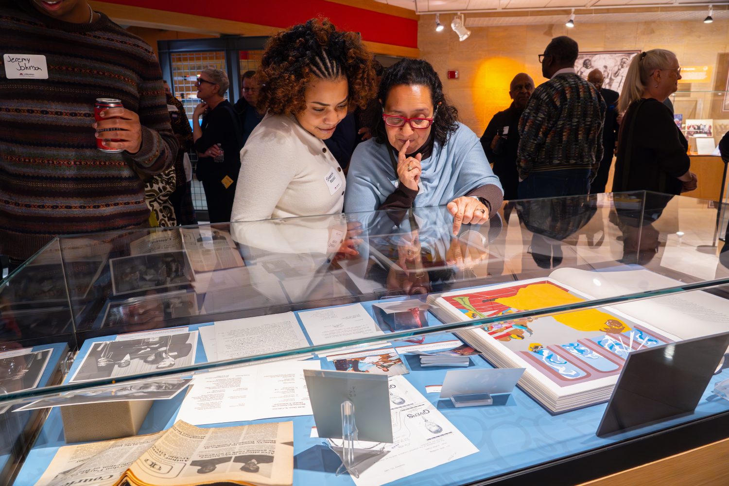Attendees walk through "The Circle Unbroken," an exhibit celebrating the 40th anniversary of the Givens Collection. (Photo/Craig Bares)