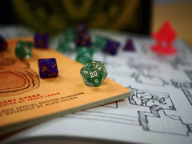 Polyhedral dice strewn across a map and an original Dungeons and Dragons booklet.