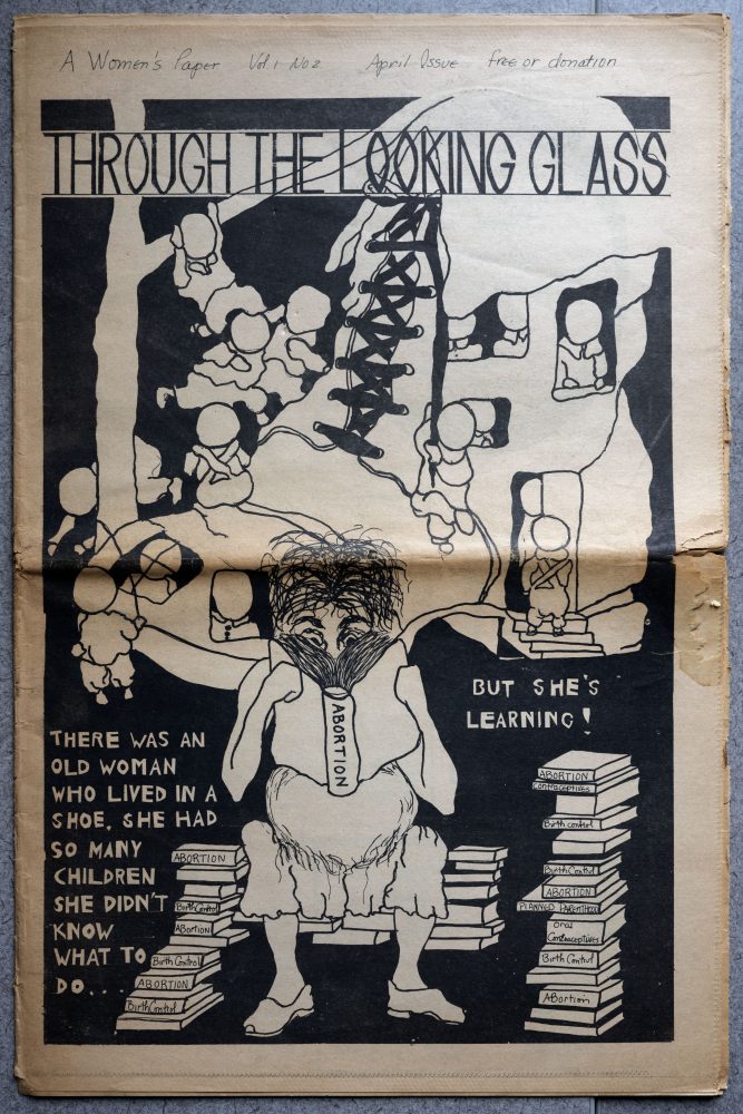 Woman who lives in a shoe, reading a stack of books.