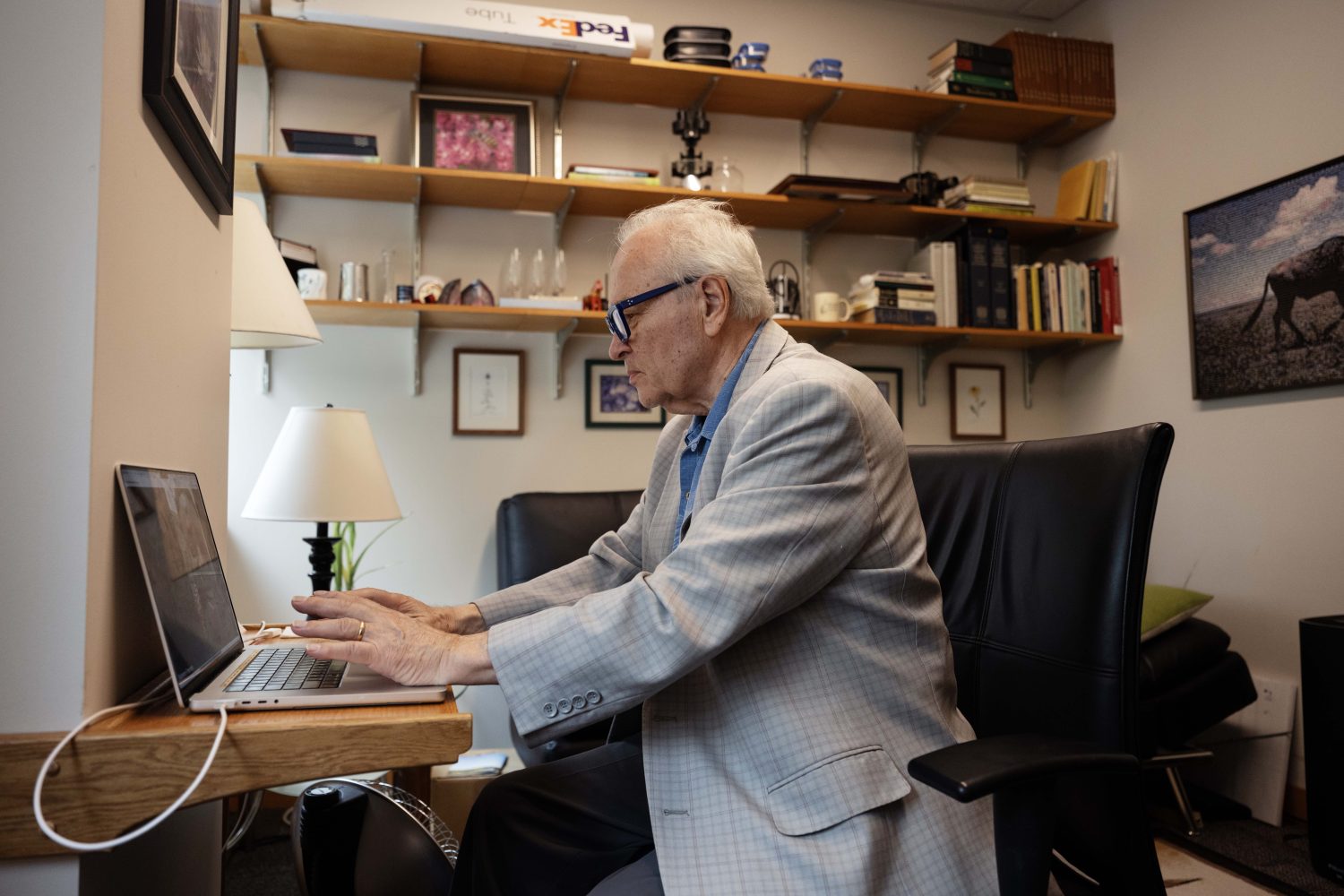 Man in office working on laptop.